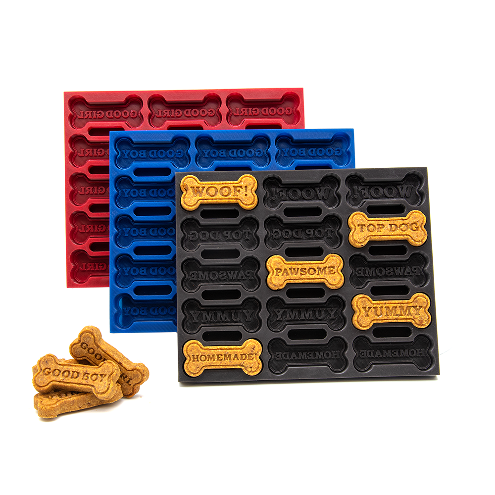 Set of dog treat molds in red, blue, and black with printed text and bones on a white background.