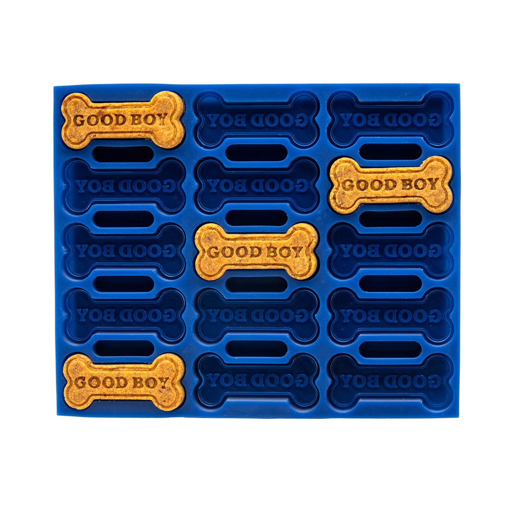 Blue silicone mold with yellow bone-shaped treats labeled 'GOOD BOY' on a white background