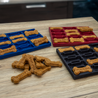 Dog treat molds with freshly baked treats on a wooden surface