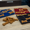 Dog treat molds with freshly baked treats on a wooden surface